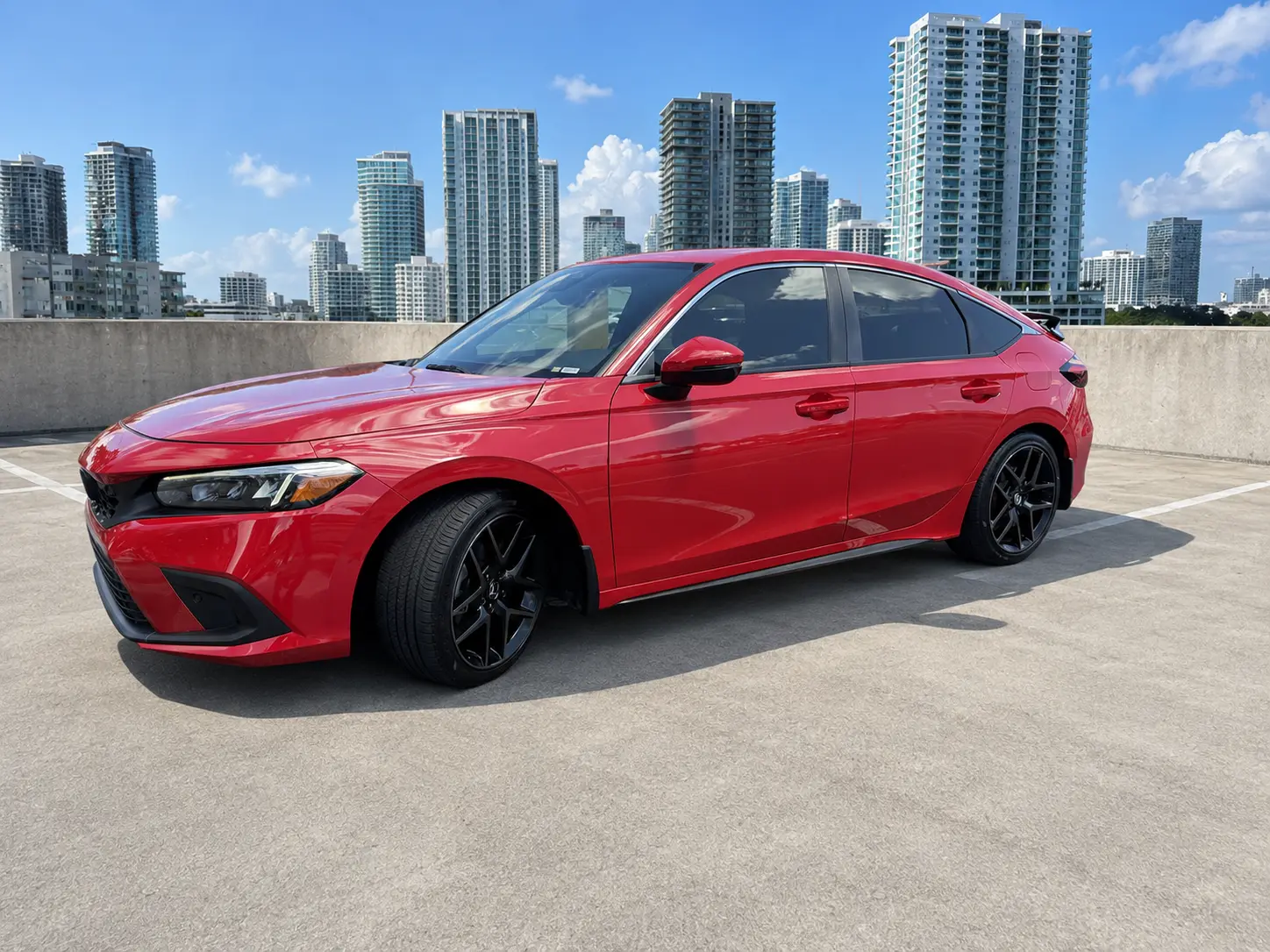 2024 Honda Civic Sport Touring Hatchback side profile on a South Florida rooftop deck